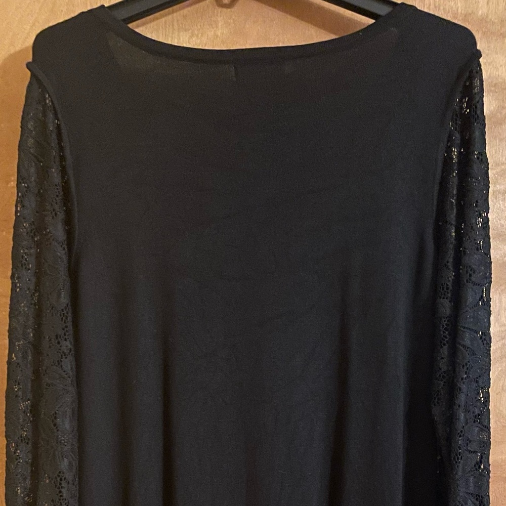Black Calvin Klein dress with lace sleeves and gold zippers